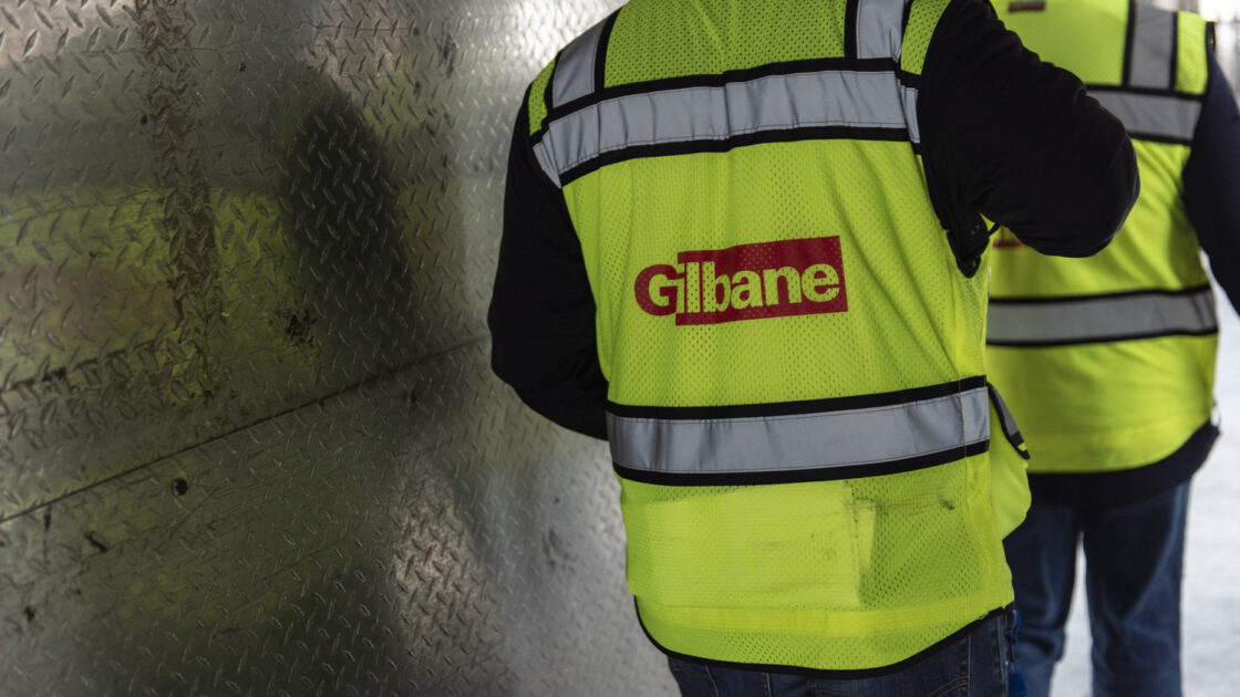 Man wearing a Gilbane yellow safety vest